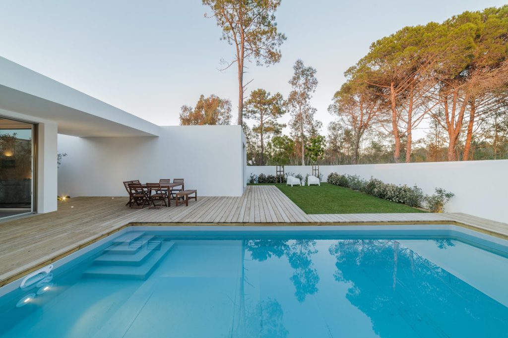 Modern house with garden swimming pool and wooden deck