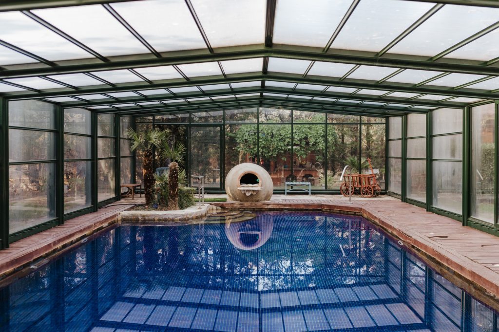 Nice indoor swimming pool view with blue water. summertime, lifestyle indoors