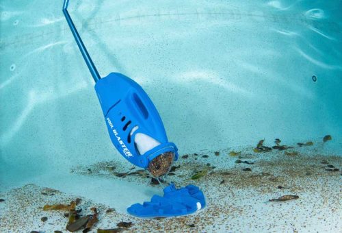 A hand-held cleaner immersed into the pool, cleaning the bottom of the pool.