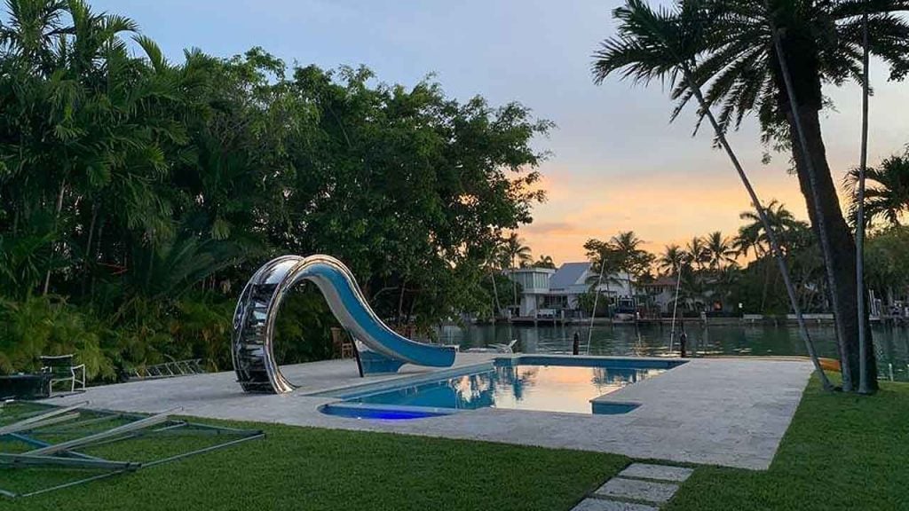 Coral stone pool deck with Splinterworks architectural slide.